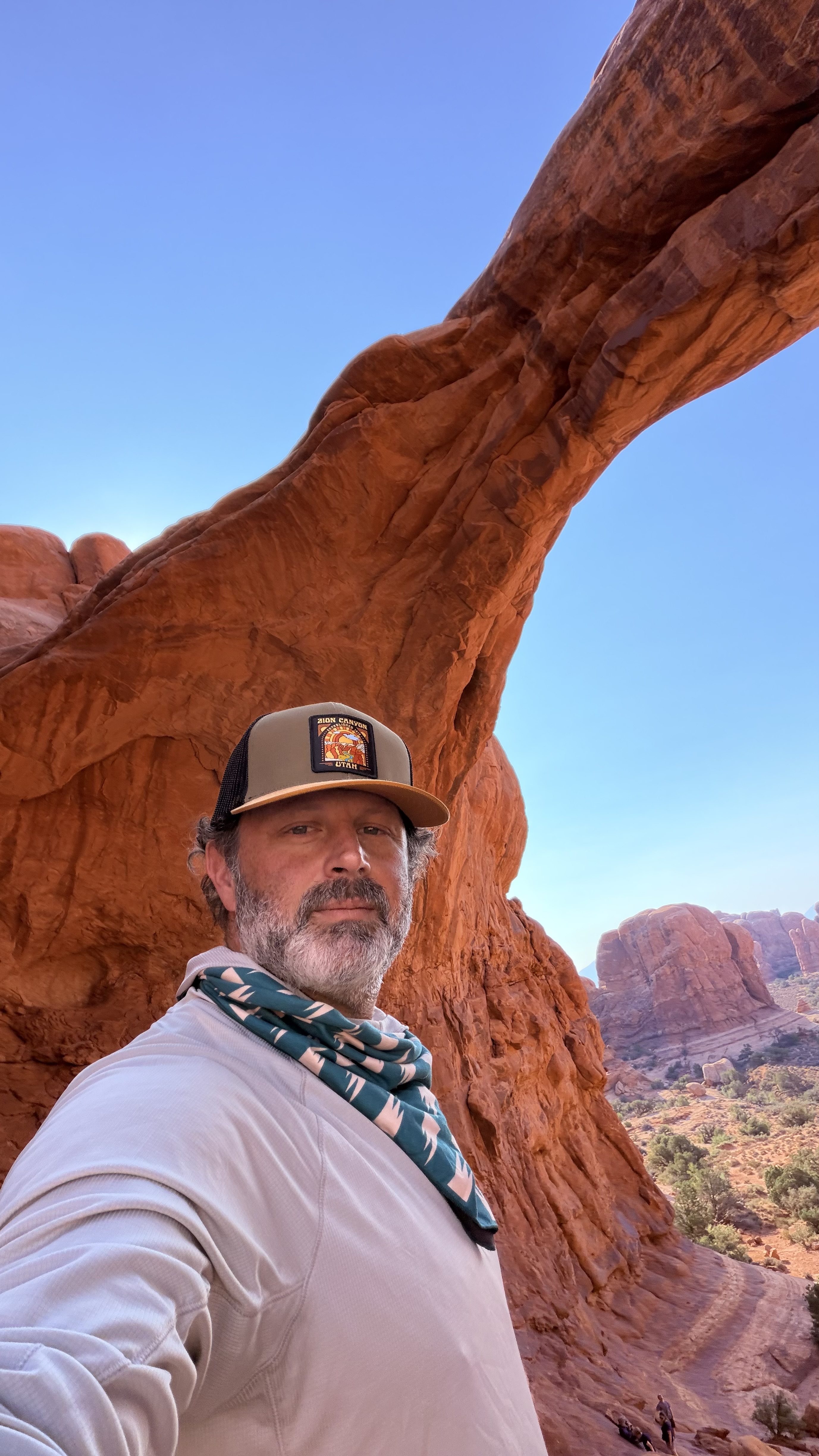 Buster Caballero beneath a red rock arch on a family adventure